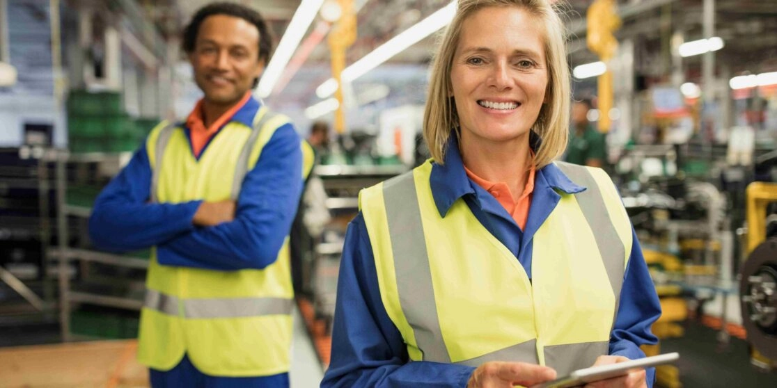 Quality Inspector holding a tablet in an automotive production line