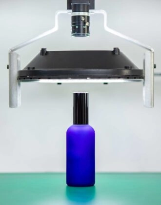 Inspecting a bottle using Spark, our automated optical inspection device