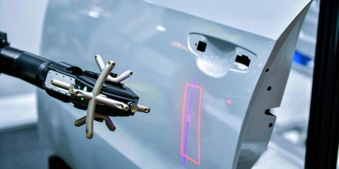 3D scanner on a robotic arm measures the precision of automotive components.