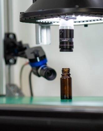 Spark, automated optical inspection device inspecting a small bottle