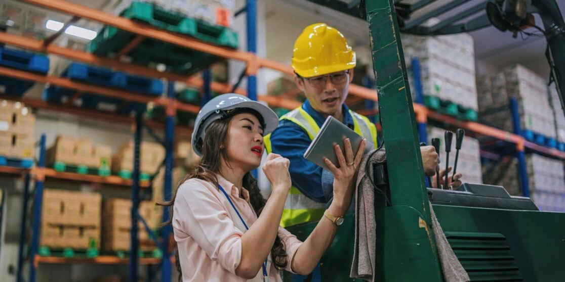 Malaysian Quality engine er and Quality Manager checking data on a tablet