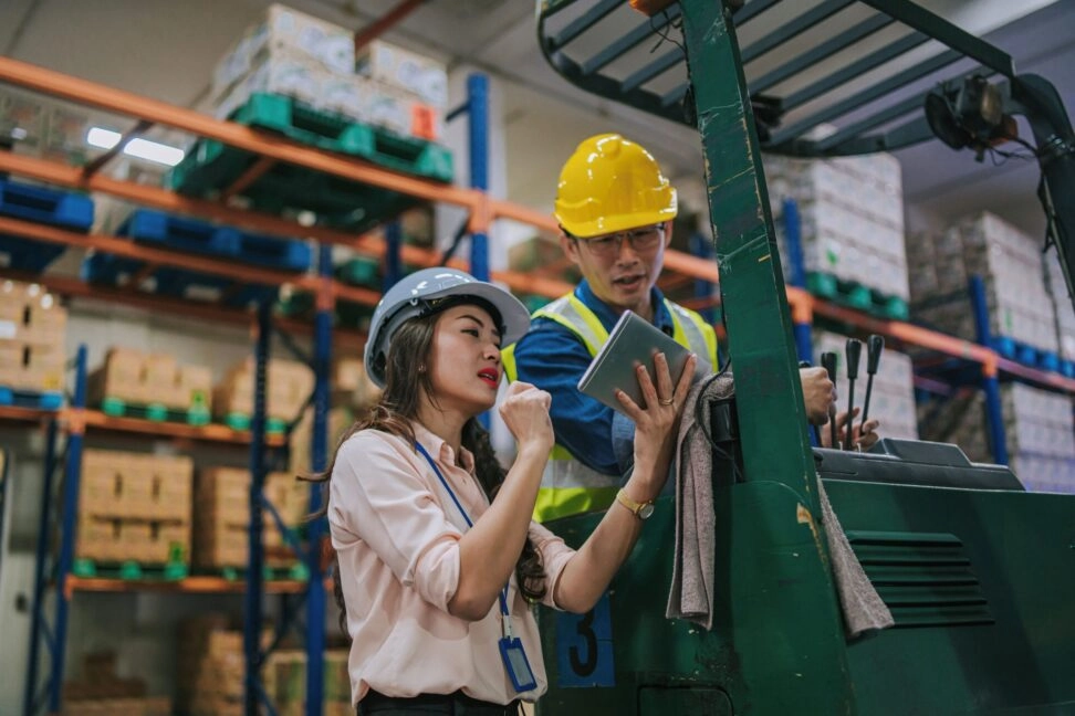 Malaysian Quality engine er and Quality Manager checking data on a tablet