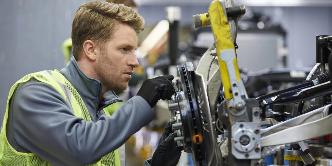 Male engineer examining car chassis