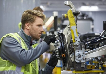 Male engineer examining car chassis