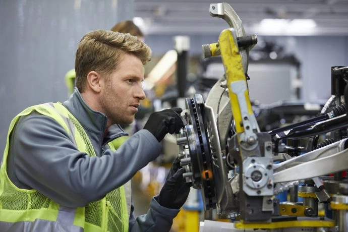Male engineer examining car chassis